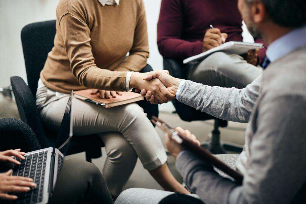 Business owner giving a handshake to a newly hired employee in Singapore