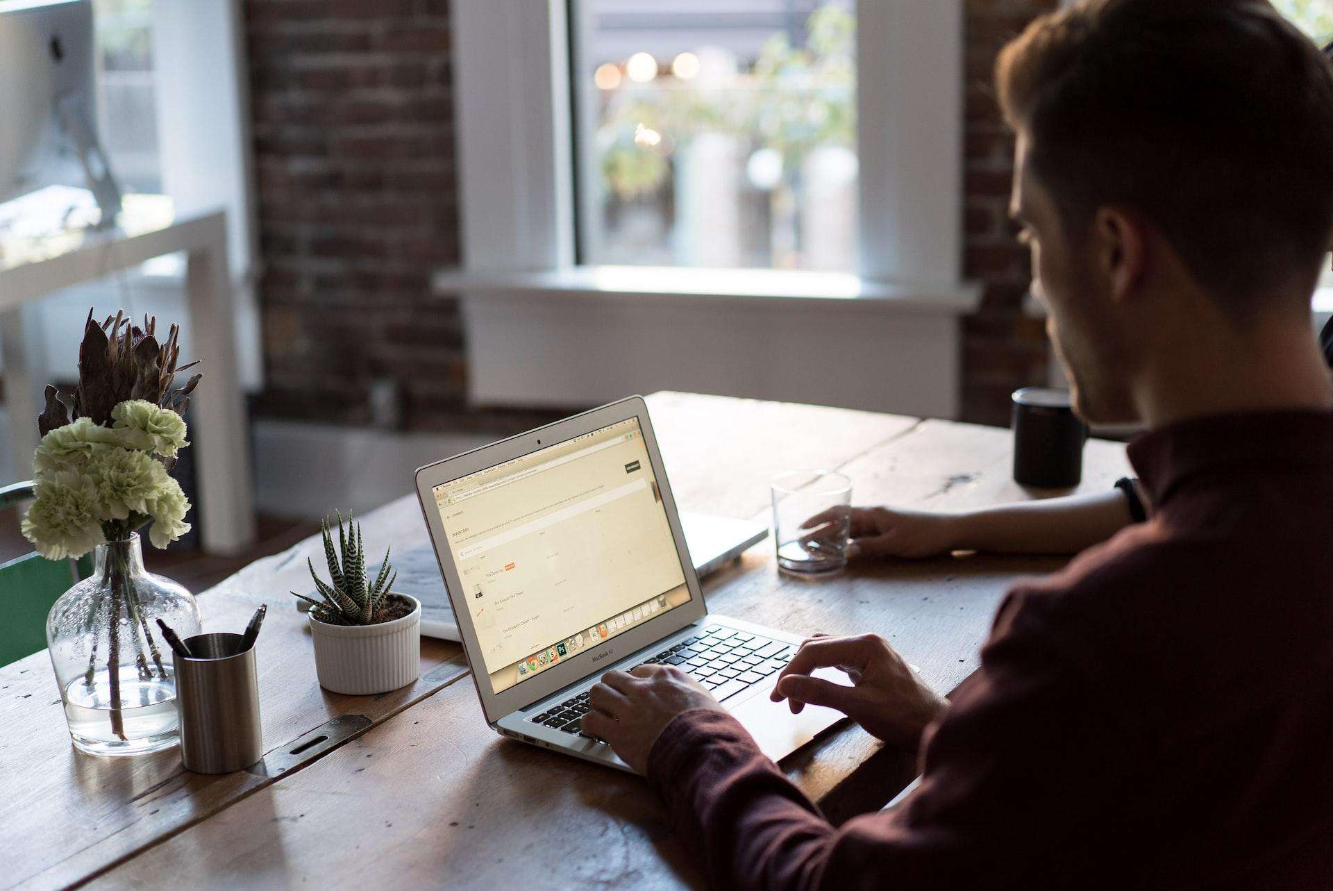 Business owner using his laptop to apply for a corporate account with Singapore banks