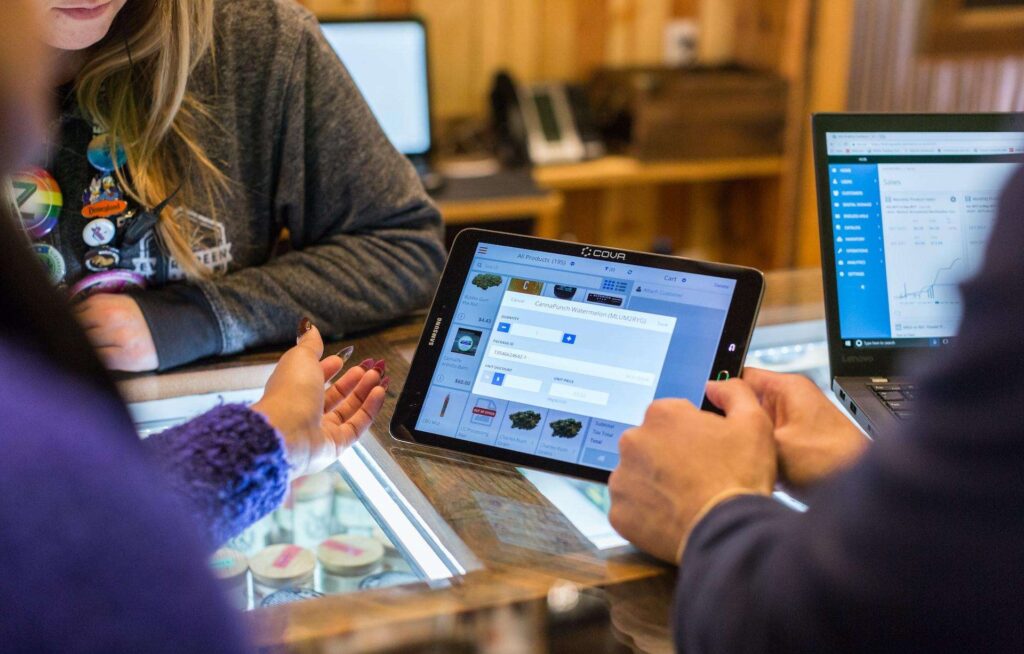 Three foreigners working on a desk with a mobile device to register a company in Singapore