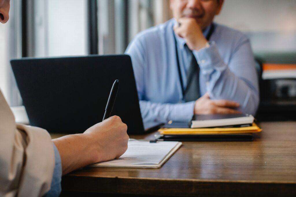 Company secretary signing a document to maintain a company's compliance with its responsibilities and requirements