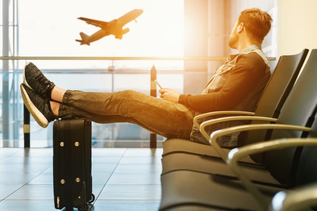 Business traveler sitting in an airport while awaiting fast entry into Singapore with the Asia Business Travel Card (ABTC)