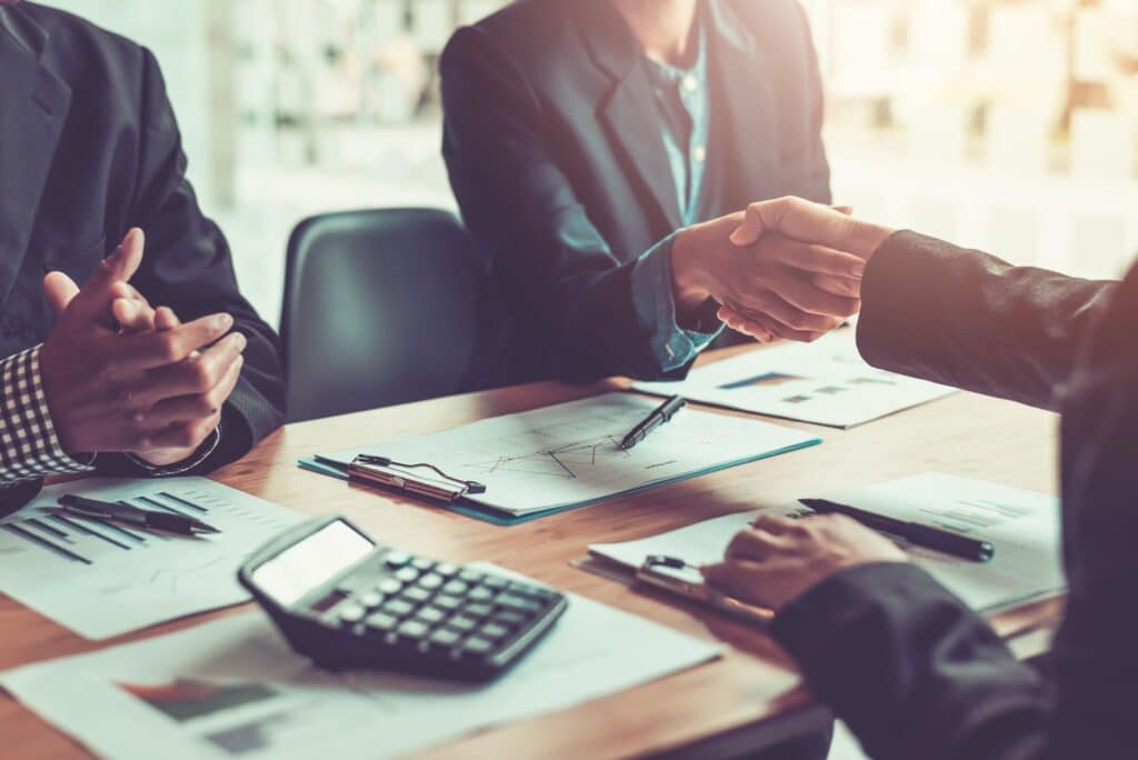 Business owner shaking hands with a registered filing agent when incorporating an Exempt Private Company in a Singapore office