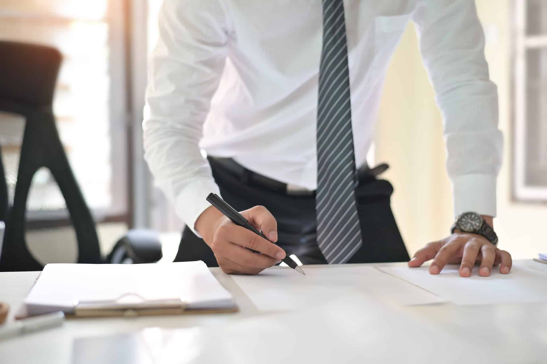 Nominee director in Singapore signing an agreement with a company regarding his roles and responsibilities.